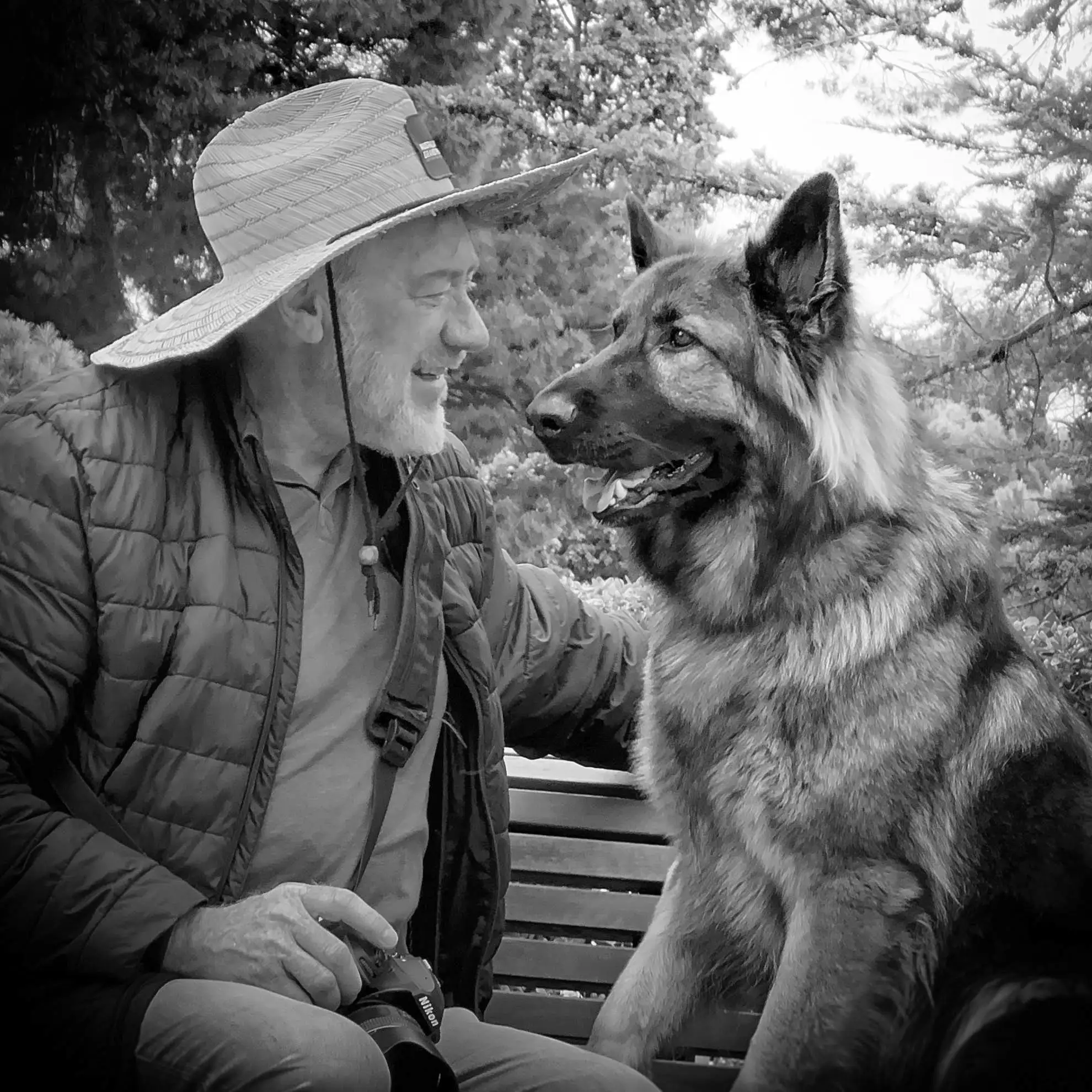 Simon sharing a quiet moment with a German Shepherd outdoors