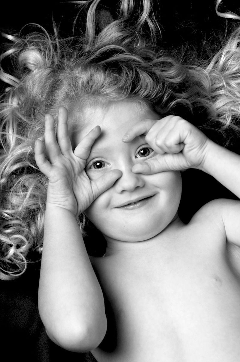 A girl making goggles with her fingers over her eyes