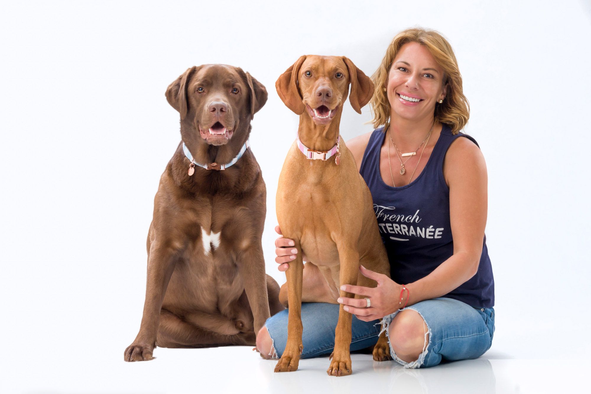 A woman with her two brown dogs sitting either side of her